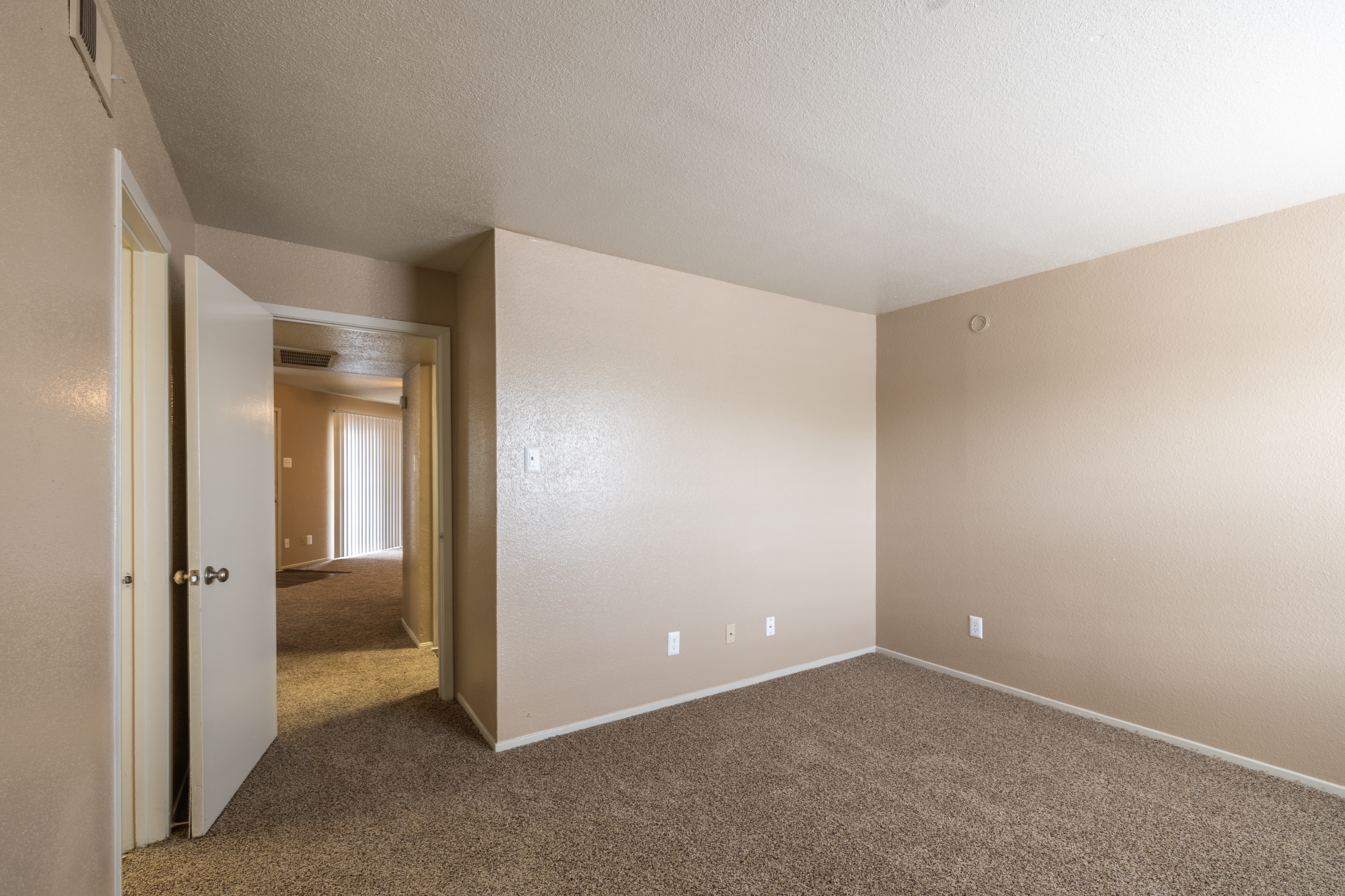 A room with carpeted floor and white walls.